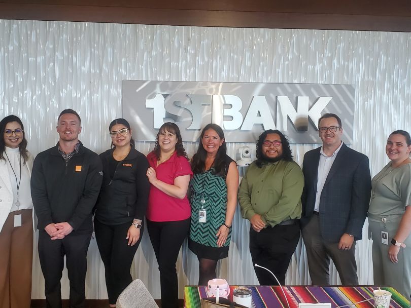 Members of FirstBank’s Latinx Employee Resource Group (ERG) pose for a group photo in the company’s office